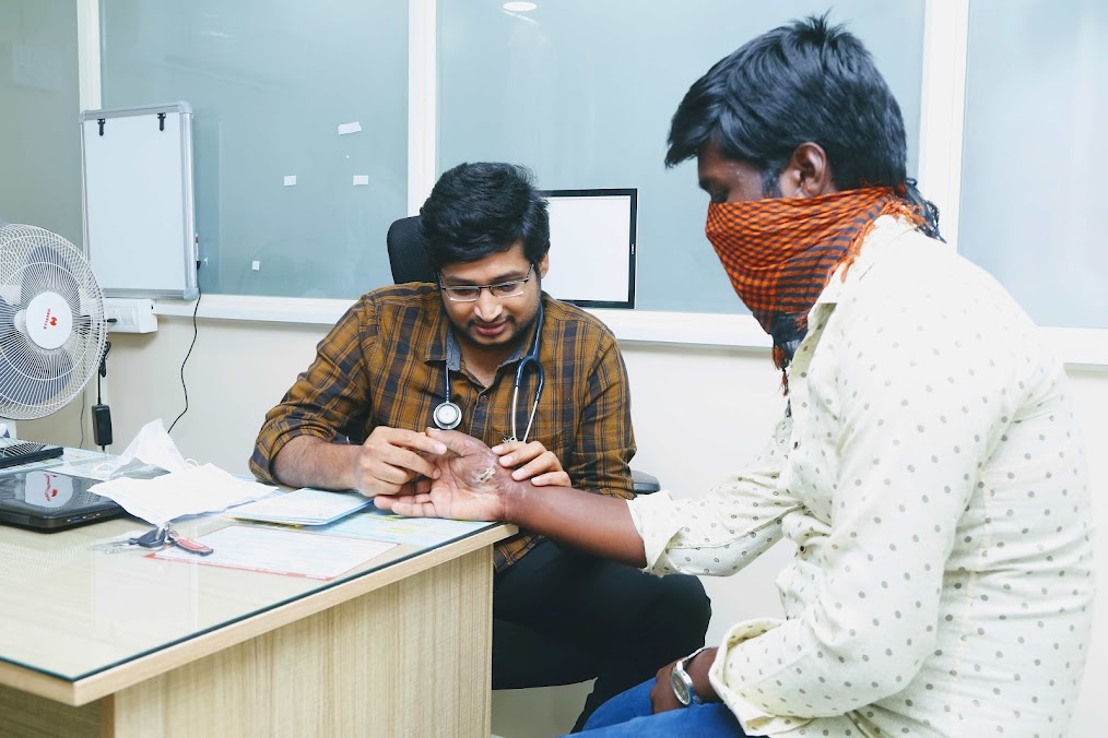 Doctor examining a patient's wrist in a consultation